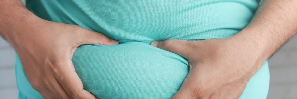 a man holding his stomach with his hands